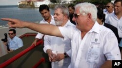 FILE - Panama's President Ricardo Martinelli (left) shows Brazil's former President Luiz Inacio Lula da Silva (second from right) an extension of the coastal strip build by Brazilian company Norberto Odebrecht in Panama City, May 20, 2011.