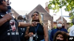 FILE- A woman addresses Minnesota Governor Tim Walz, right, during a demonstration, June 1, 2020, in St. Paul, Minn. Protests continued following the death of George Floyd, who died after being restrained by Minneapolis police officers on May 25.