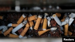 Discarded cigarette butts fill an ash tray outside an office building in Sydney, Australia, May 11, 2017. 