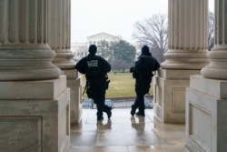 U.S. Capitol Police officers stand watch outside the Senate as lawmakers vote on procedures to proceed with the impeachment of former President Donald Trump for inciting the January 6, 2021.