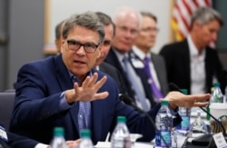 FILE - Energy Secretary Rick Perry, left, speaks at a discussion on the importance of American leadership in artificial intelligence at the Lawrence Livermore National Laboratory, Livermore, Calif., Aug. 26, 2019.