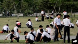 FILE - North Korean school children groom the lawn in Pyongyang, North Korea, June 16, 2017.