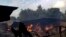 A timber depot burns in Mullegama village in Kandy, Sri Lanka, Wednesday, March. 7, 2018.