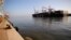 FILE - A cargo ship docks as its cargo is unloaded at Haifa's port, northern Israel, Oct. 12, 2020.