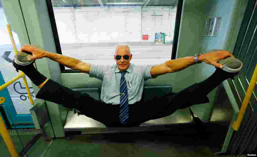 Bodybuilding tram driver Peter Wirth, alias &#39;Bahnbabo&#39; practices gymnastics in a tram in Frankfurt, Germany, Aug. 1, 2019.