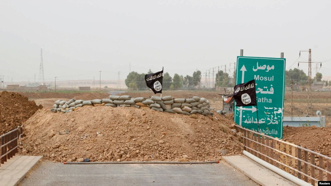 Islamic State flags flutter on the Mullah Abdullah bridge in southern Kirkuk, Iraq, Sept. 29, 2014. 