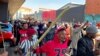 Stick-wielding protesters march through the streets as violence following the jailing of former South African President Jacob Zuma spread to the country's main economic hub in Johannesburg, South Africa, July 11, 2021. REUTERS/ Siphiwe Sibeko