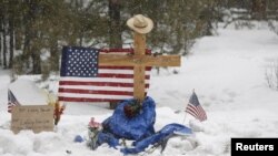 A memorial for Robert “LaVoy” Finicum is seen where he was shot and killed by law enforcement on a highway north of Burns, Ore., Jan. 30, 2016. Four occupiers remain holed up at the Malheur National Wildlife Refuge south of Burns, saying they will not leave without assurances they won't be arrested.