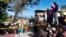 FILE - People stand outside the Orphanage of the Church of Bible Understanding outside Port-au-Prince, Haiti, on Feb. 14, 2020. A fire broke out at the children's home the previous night. 