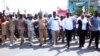 FILE - The party's deputy chairman, Tundu Lissu, front center, and supporters of Tanzania's main opposition party, Chadema, protest in Dar es Salaam, Tanzania, Wednesday, Jan. 24, 2024.