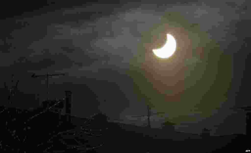 The moon passes in front of the sun during a partial solar eclipse in Moscow, Russia, Tuesday, Jan. 4, 2011. A partial solar eclipse that began over the Mideast extended across much of Europe. (AP Photo/Misha Japaridze)