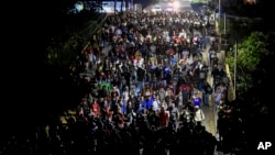 Migrants walk through Tapachula, Chiapas state, Mexico, Jan. 2, 2025, in an attempt to reach the U.S. border. 