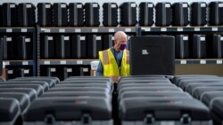FILE - A worker prepares tabulators for the upcoming election at the Wake County Board of Elections in Raleigh, N.C., Sept. 3, 2020.