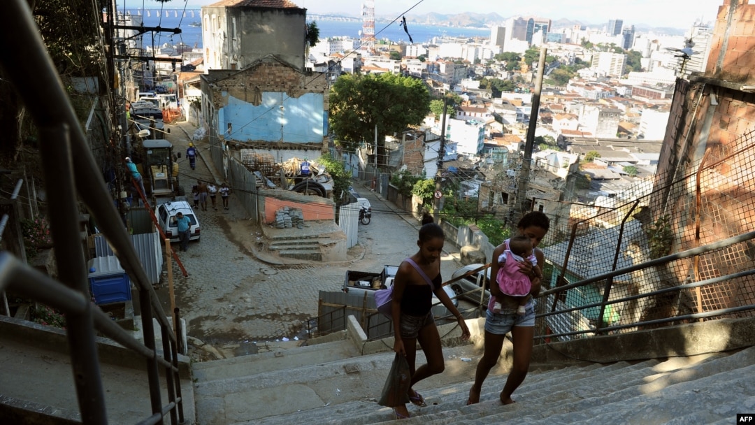 Locals walk in the Morro Da Providencia shantytown in Rio de Janeiro, Aug. 17, 2012. Hundreds of families were evicted from Rio favelas because of preparation work needed for the 2014 FIFA World Cup and the 2016 Olympic Games.