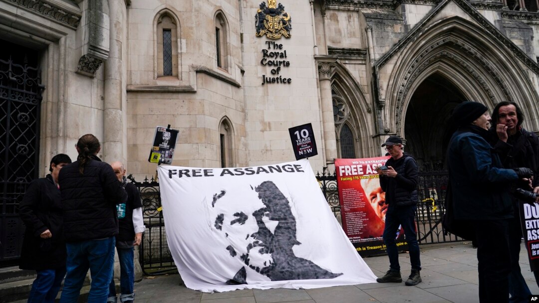 A banner in support of WikiLeaks founder Julian Assange is attached outside the Royal Courts of Justice, in London, Oct. 23, 2021, ahead of an upcoming extradition case appeal. 