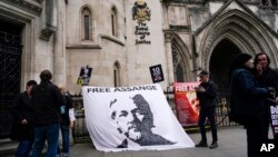 A banner in support of WikiLeaks founder Julian Assange is attached outside the Royal Courts of Justice, in London, Oct. 23, 2021, ahead of an upcoming extradition case appeal. 