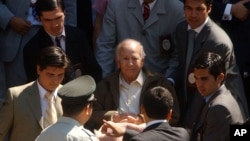 FILE - Paul Schaefer, 83, founder and former leader of a commune-like colony in southern Chile, is wheeled to a corrections vehicle to be transferred to prison, in Santiago, Chile, March 14, 2005.