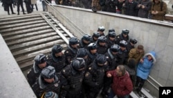 FILE - Police block the way to prevent people attending an opposition rally in Pushkin Square in Moscow, Dec. 12, 2015.