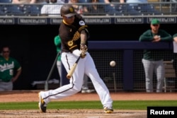 San Diego Padres third baseman Manny Machado (13) hits against the Oakland Athletics in the first inning at Peoria Sports Complex, Peoria, Arizona, March 5, 2023.