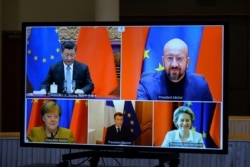 FILE - European Commission President Ursula von der Leyen, European Council President Charles Michel, German Chancellor Angela Merkel, French President Macron and Chinese President Xi Jinping hold a video conference, Dec. 30, 2020.