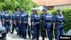 German police officers search property around the house of District President of Kassel Walter Luebcke, who was found dead in Wolfhagen-Istha near Kassel, Germany, June 3, 2019.