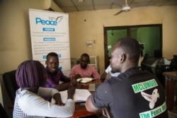 Lupai Samuel Stephen, director of an organization called I Am Peace Initiative, sits with his team to organize the upcoming Peace Camp program in Juba, South Sudan. (Chika Oduah/VOA)