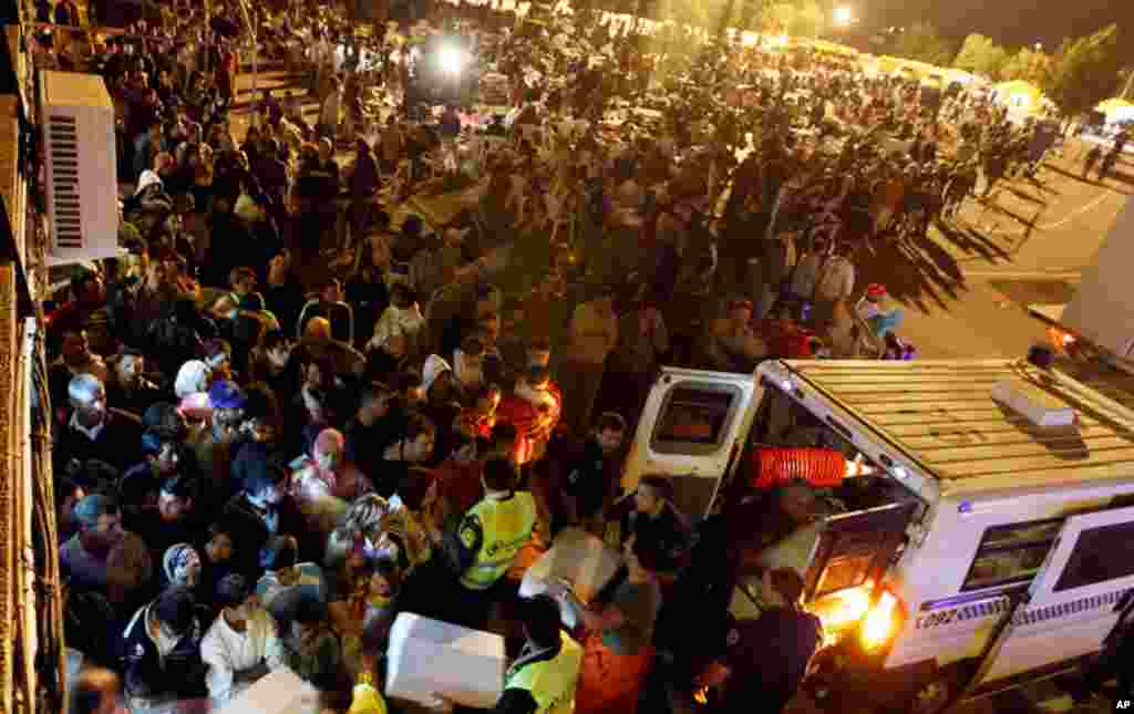 May 12: Ambulance workers tend to folks who are spending the night outside their homes in Lorca, Spain, following the earthquakes on Wednesday night. (AP Photo/Alberto Saiz)