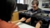 The "rubber hand illusion" has been used in psychological experiments for nearly two decades. Here, at Vanderbilt University, a researcher uses a pair of brushes to test a participant’s perception. (Vanderbilt University / John Russell)