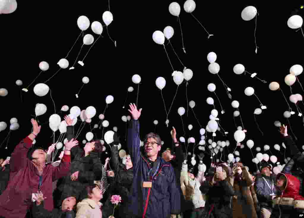 People release balloons into the air to celebrate New Year at a hotel in Tokyo, Japan, Jan. 1, 2017.