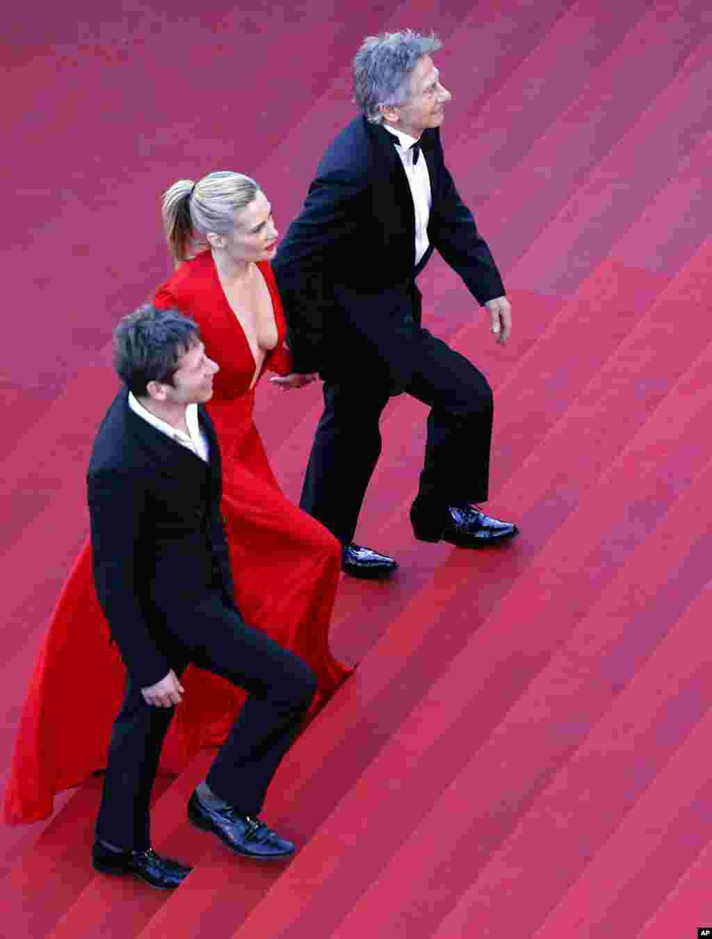 Roman Polanski, actress Emmanuelle Seigner, and actor Mathieu Amalric arrive for the screening of the film "Venus in Fur" during the 66th Cannes Film Festival, May 25, 2013.