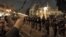 Egyptian protesters stand in front of barbed wire beyond the presidential palace in Cairo, December 4, 2012.