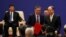 FILE - Vice chairman and president of China Investment Corporations (CIC) Tu Guangshao, chairman of the Board of Directors of the Bank of China Chen Siqing and president of Sinopec Group Dai Houliang attend signing ceremony and meeting of business leaders with U.S. President Donald Trump and China's President Xi Jinping at the Great Hall of the People in Beijing, China, Nov. 9, 2017. 