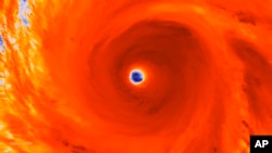 The eye-wall of Super Typhoon Maysak is seen as it heads west-northwestward through the western Pacific Ocean.