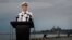 Commander of the U.S. Pacific Fleet Scott Swift answers questions during a press conference with the USS John S. McCain and USS America docked in the background at Singapore's Changi naval base in Singapore, Aug. 22, 2017.