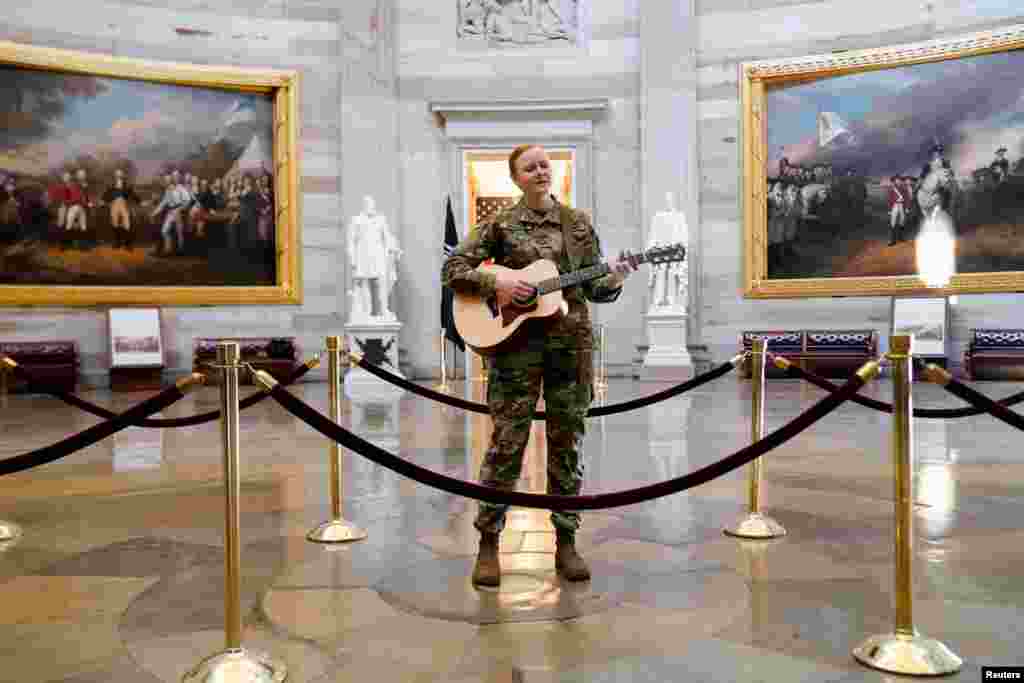 Michigan National Guard member Sgt. Hannah Boulder plays guitar and sings in the U.S. Capitol Rotunda in Washington, D.C., March 10, 2021.