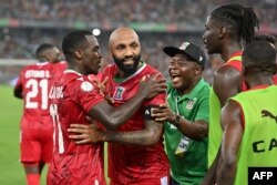 FILE - Equatorial Guinea's forward #10 Emilio Nsue (C) celebrates with teammates after scoring his team's third goal at the AFCON 2024 group A match between Equatorial Guinea and Ivory Coast at the Alassane Ouattara Olympic Stadium in Ebimpe, Abidjan on January 22, 2024