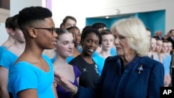 FILE—Britain's Camila, The Queen Consort, meets Nigerian dancer Anthony Madu during a visit to Elmhurst Ballet School to celebrate the school's centenary in Birmingham, England, March 14, 2023. 