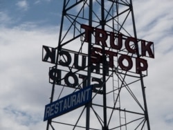 Tower sign advertising a truck stop in Van Horn, Texas, 26 June 2008.