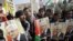 Palestinians shout slogans to support Palestinian President Mahmoud Abbas ahead of his meeting with U.S. President Barack Obama Monday, Tubas, West Bank, March 16, 2014.