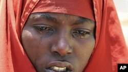 An internally displaced Somali woman mourns near the body of her son, who died of malnourishment, next to their temporary home in Hodan district, south of Somalia's capital Mogadishu, (File).