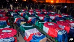 In this handout photo released by Pakistan's Police Department, security officials gather for funeral prayers of police officer, who were killed in the suicide bombing inside a mosque, in Peshawar, Pakistan, Jan. 30, 2023. 