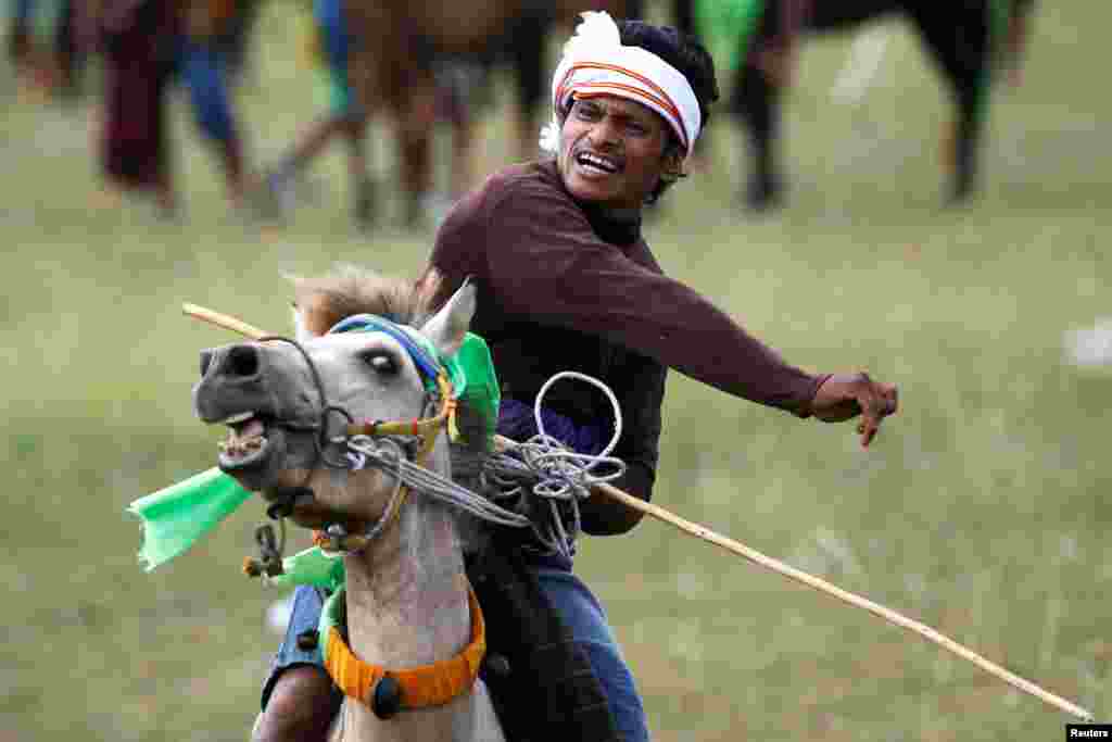 A Sumbanese man reacts as he throws a javelin during the Pasola &#39;war&#39; festival, an annual ancient ritual to welcome the new harvest season, in Lamboya district, West Sumba, East Nusa Tenggara province, Indonesia.