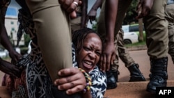 FILE - Stella Nyanzi, a prominent Ugandan activist, is arrested by police on May 18, 2020, after she organized a protest for more food distribution by the government to people who have been financially struggling because of the nationwide lockdown.