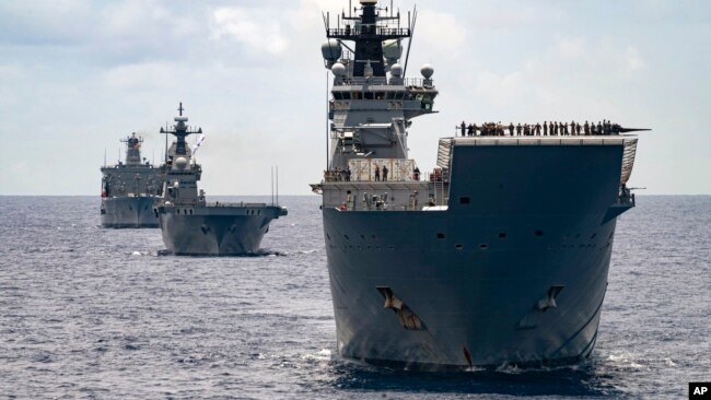 FILE - In this undated photo provided by the Australian Defense Force, Royal Australian Navy Ships Canberra, Supply and Warramunga sail in formation with 37 ships during Exercise Rim of the Pacific 2022.