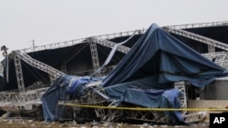Indiana State Police and authorities survey the collapsed rigging and Sugarland stage on the infield at the Indiana State Fair in Indianapolis, August 14, 2011