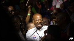 FILE - Mayoral candidate Eric Adams mingles with supporters during his election night party, June 22, 2021, in New York. 