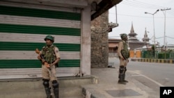 Indian paramilitary soldiers stand guard at a market in Srinagar, Indian-controlled Kashmir, July 13, 2019.