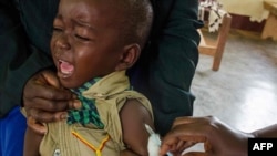 A child reacts as he receives an injection during the nationwide vaccination campaign against measles, rubella and polio targeting all children younger than 15 in Nkozi town, about 84 km from the capital Kampala, Uganda, Oct. 19, 2019.