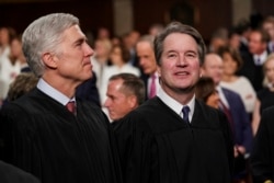 FILE - Supreme Court Associate Justices Neil Gorsuch, left, and Brett Kavanaugh watch as President Donald Trump arrives to give his State of the Union address to a joint session on Congress at the Capitol in Washington, Feb. 5, 2019.