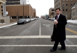 Mayor Pete Buttigieg talks with an AP reporter as he walks in downtown South Bend, Ind., Jan. 10, 2019.